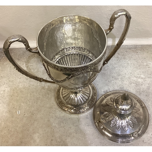 55 - A large and impressive 19th Century George III silver trophy cup and cover embossed with vines, foli... 