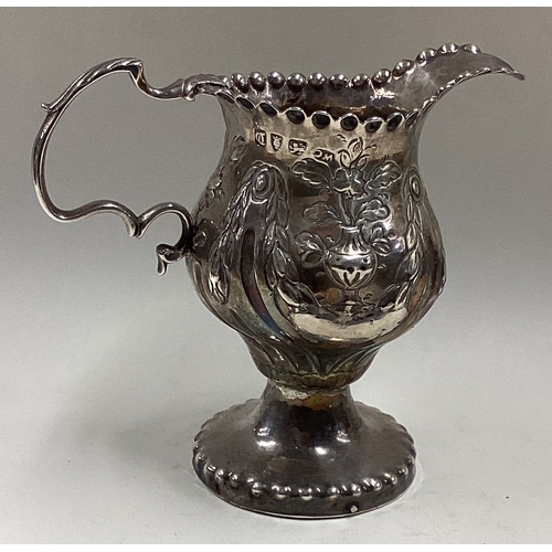 564 - An 18th Century George III silver jug with chased decoration. London 1758. Approx. 90 grams. Est. £8... 