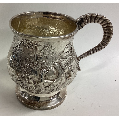 582 - A fine quality Georgian silver christening mug decorated with animals. London. By IF. Approx. 112 gr... 