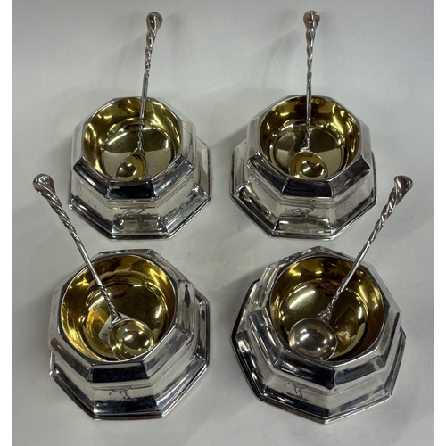 597 - A set of four octagonal Victorian silver salts in the Georgian style complete with salt spoons. Lond... 