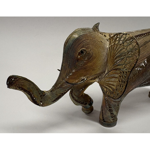 632 - An Indian silver figure of an elephant with filigree decoration. Approx. 61 grams. Est. £60 - £80.