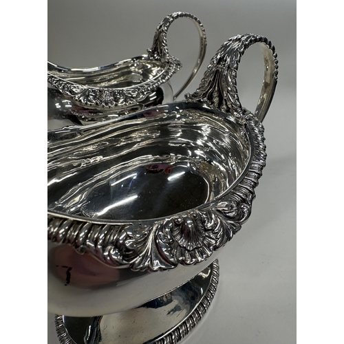 650 - A clean pair of George III silver sauceboats with shell border and crested decoration. London 1801. ... 