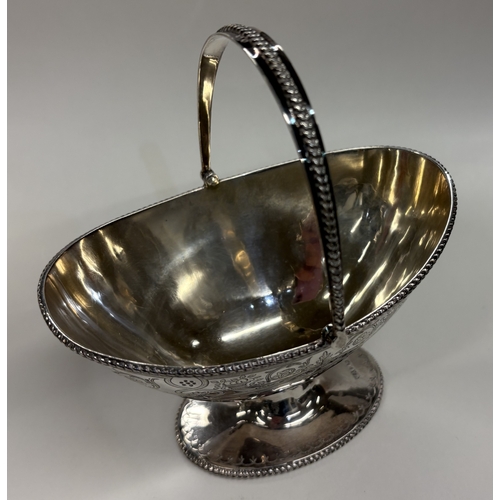 668 - A good Victorian silver swing-handled basket with engraved decoration. Sheffield 1881. By Henry Aitk... 