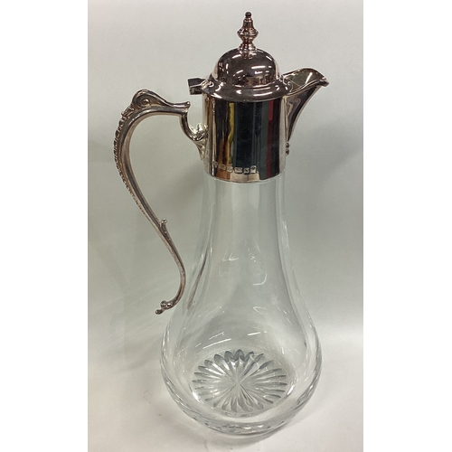 672 - A plain silver mounted glass lemonade jug with hinged cover. London. By CV & Co. Est. £80 - £120.