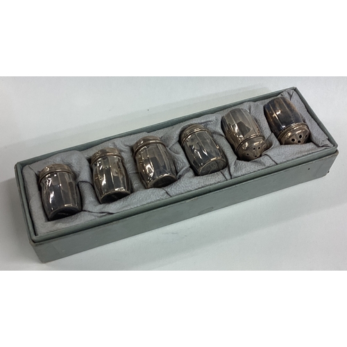 677 - A boxed set of six Continental silver peppers. Approx. 14 grams. Est. £20 - £30.