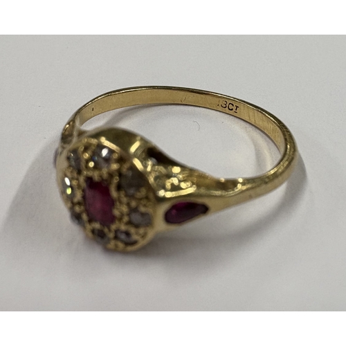 701 - A small 18 carat gold ruby and diamond ring. Approx. ring size N. Approx. 2 grams. Est. £50 - £80.