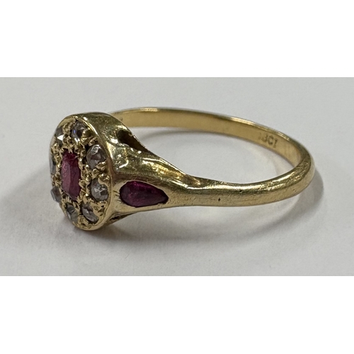 701 - A small 18 carat gold ruby and diamond ring. Approx. ring size N. Approx. 2 grams. Est. £50 - £80.