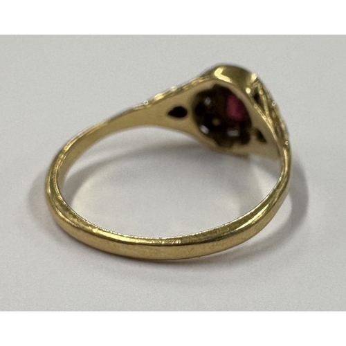 701 - A small 18 carat gold ruby and diamond ring. Approx. ring size N. Approx. 2 grams. Est. £50 - £80.