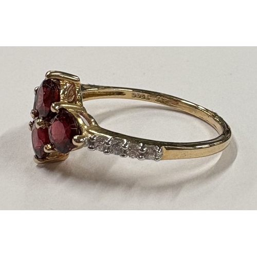 714 - A heavy garnet and diamond ring in 10 carat gold setting. Approx. ring size P 1/2. Approx. 3 grams. ... 