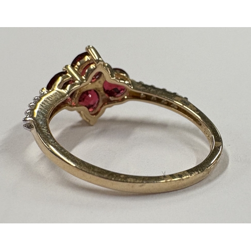 714 - A heavy garnet and diamond ring in 10 carat gold setting. Approx. ring size P 1/2. Approx. 3 grams. ... 