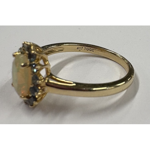 715 - A small 10 carat green stone set cluster ring. Approx. ring size P. Approx. 3 grams. Est. £60 - £80.