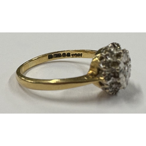 717 - An 18 carat gold diamond set cluster ring. Approx. ring size M. Approx. 3 grams. Est. £60 - £80.