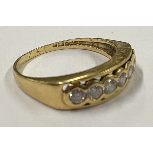 720 - An 18 carat gold seven-stone diamond ring in rub over setting. Approx. ring size O. Approx. 4 grams.... 