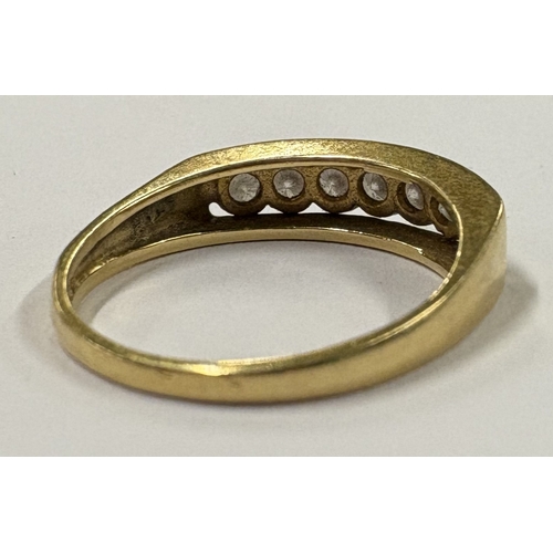 720 - An 18 carat gold seven-stone diamond ring in rub over setting. Approx. ring size O. Approx. 4 grams.... 