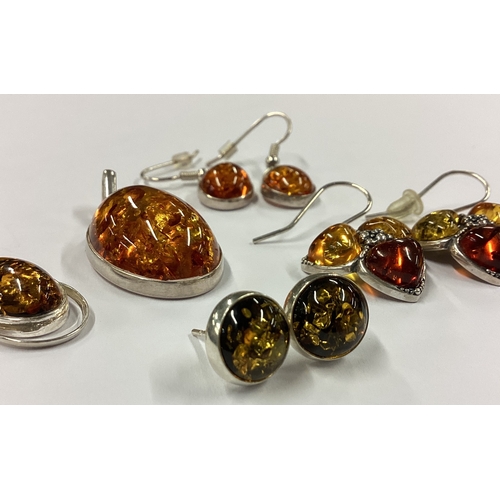 725 - A collection of silver and amber mounted earrings and pendants. Approx. 16 grams. Est. £10 - £20.