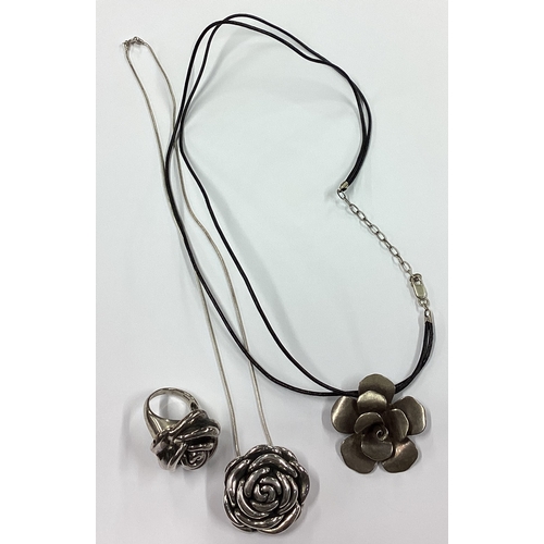 726 - A silver flower-shaped pendant together with matching ring etc. Approx. 33 grams. Est. £20 - £30.