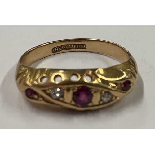 731 - An 18 carat gold ruby and diamond ring. Approx. ring size R. Approx. 3 grams. Est. £80 - £120.