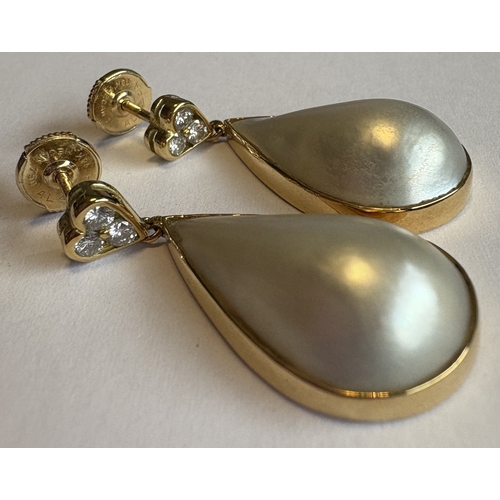 756 - A good pair of pearl and diamond earrings of tear drop design in 18 carat gold setting. Approx. 8 gr... 