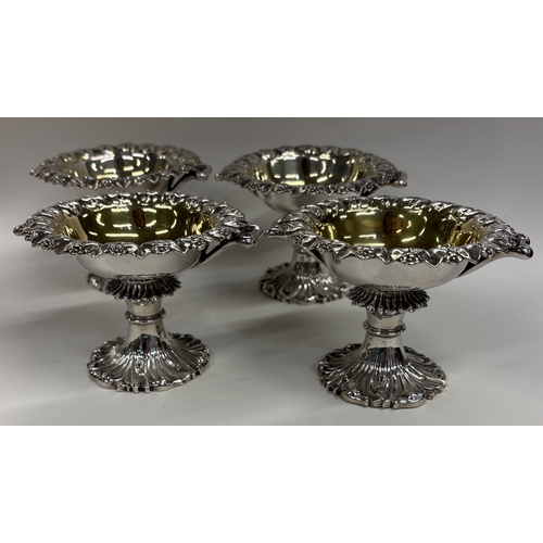 8 - An attractive set of four chased Victorian silver salt cellars with handles. London 1848. By John & ... 