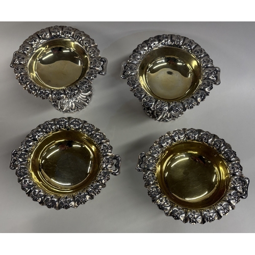 8 - An attractive set of four chased Victorian silver salt cellars with handles. London 1848. By John & ... 