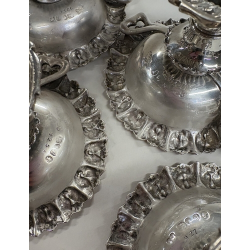 8 - An attractive set of four chased Victorian silver salt cellars with handles. London 1848. By John & ... 