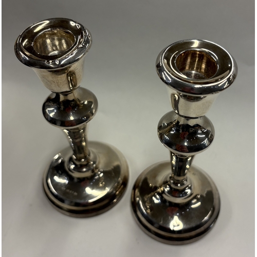 96 - A pair of silver candlesticks. Birmingham 1957. Approx. 256 grams. Est. £60 - £80.