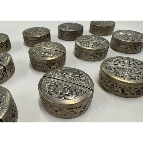 97 - A set of twelve Cambodian silver menu holders with chased decoration. Marked to bases. Est. £100 - £... 