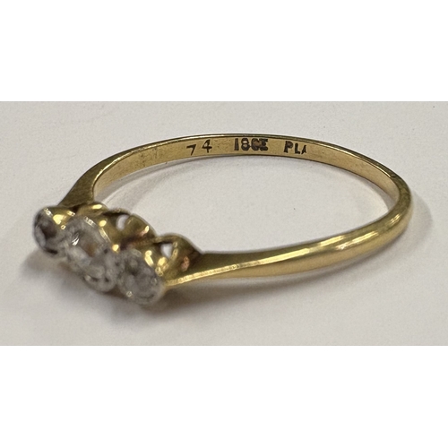 774 - An 18 carat gold mounted three-stone diamond ring. Approx. ring size S 1/2. Approx. 3 grams. Est. £1... 