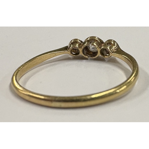 774 - An 18 carat gold mounted three-stone diamond ring. Approx. ring size S 1/2. Approx. 3 grams. Est. £1... 