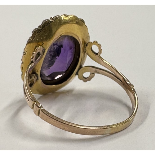 781 - A good Antique amethyst and pearl ring with scroll mounts. Approx. ring size P. Approx. 4 grams. Est... 