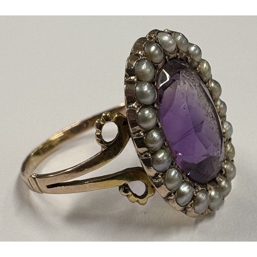 781 - A good Antique amethyst and pearl ring with scroll mounts. Approx. ring size P. Approx. 4 grams. Est... 