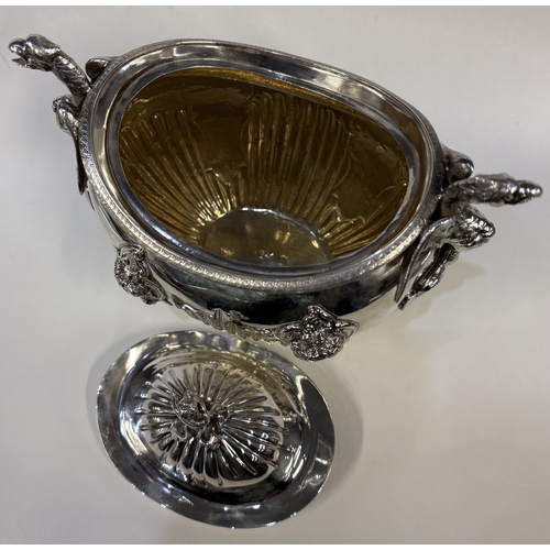 689 - A 19th Century silver figural tea caddy / sugar box and cover with cast dragon handles and embossed ... 