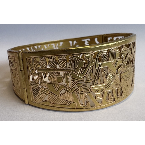 791 - A tapering 18 carat Egyptian gold mounted bracelet with pierced decoration to concealed clasp. Appro... 