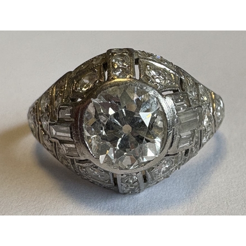 794 - A good French platinum ring with large central diamond to reeded shoulder. Approx. ring size Q. Appr... 