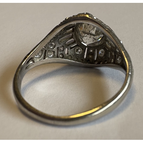 794 - A good French platinum ring with large central diamond to reeded shoulder. Approx. ring size Q. Appr... 