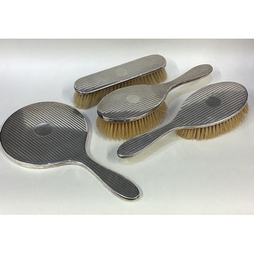 696 - A matched silver mounted brush and mirror set. London 1922/23. By Charles & Richard Comyns. Approx. ... 