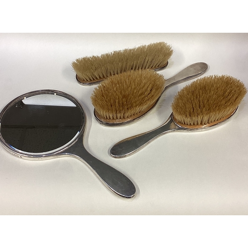 696 - A matched silver mounted brush and mirror set. London 1922/23. By Charles & Richard Comyns. Approx. ... 