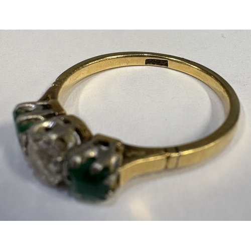 795 - A good emerald and diamond three-stone ring set in two-colour gold. Approx. ring size S. Approx. 3 g... 