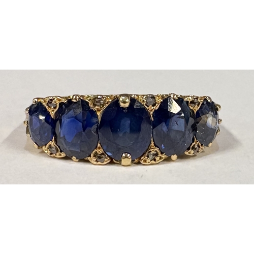 797 - A good Antique sapphire five-stone ring with diamond chips in 18 carat gold setting. Approx. ring si... 