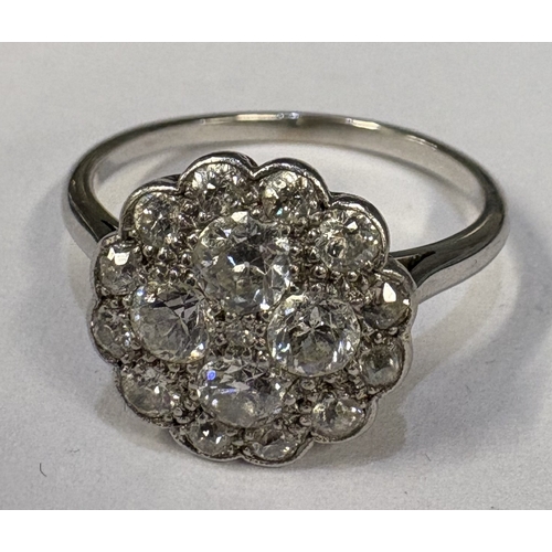 799 - An attractive diamond circular cluster ring in platinum setting. Approx. ring size Q. Approx. 4 gram... 