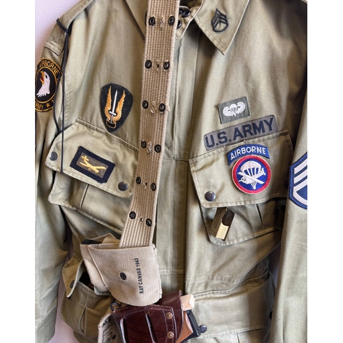 152 - A reproduction US Army 101st Airborne uniform together with replica pistol. Est. £20 - £30.