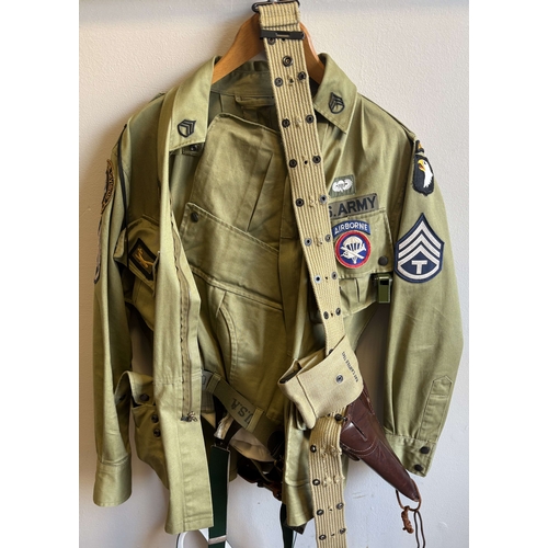 152 - A reproduction US Army 101st Airborne uniform together with replica pistol. Est. £20 - £30.