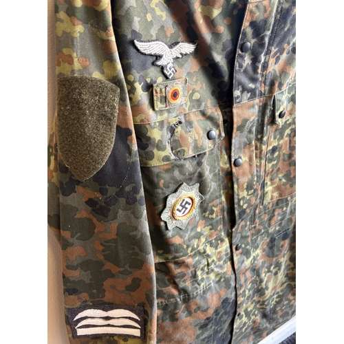 161 - A reproduction WW2 German M44 Pea Dot Tunic together with matching trousers. Est. £20 - £30.