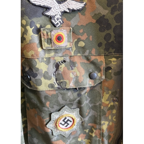 161 - A reproduction WW2 German M44 Pea Dot Tunic together with matching trousers. Est. £20 - £30.