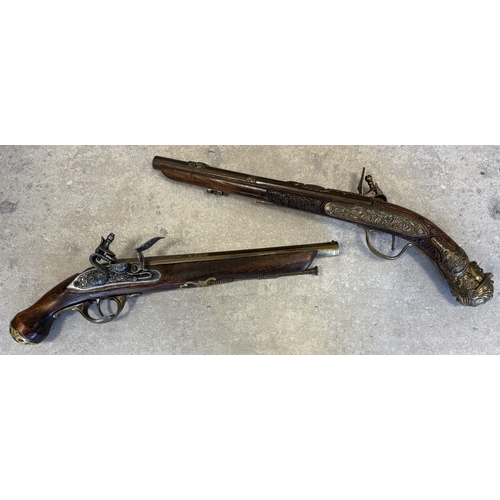 179 - Two reproduction flintlock pistols. Est. £10 - £20.