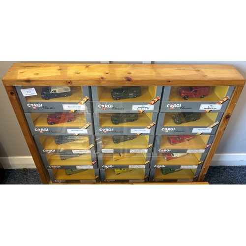 233 - Two framed and glazed display cabinets containing various 'Corgi' Morris Minor diecast model vehicle... 