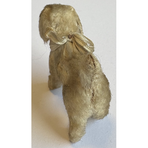 325 - STEIFF: A rare vintage mohair terrier dog with glass eyes, stud nose and ribbon. Circa 1950s. Approx... 