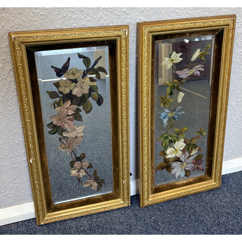 75 - A pair of gilt framed painted mirror pictures depicting flowers. Approx. 60 cm x 24 cm (ss). Est. £2... 