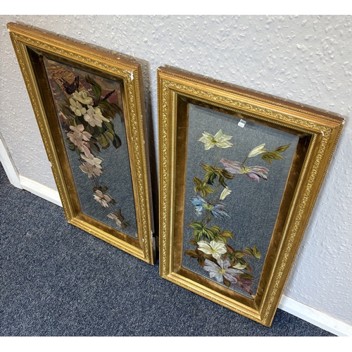 75 - A pair of gilt framed painted mirror pictures depicting flowers. Approx. 60 cm x 24 cm (ss). Est. £2... 