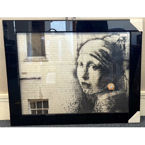88 - A framed print depicting Banksy's 'Girl with a Pierced Eardrum' with tactile raised glazing. Approx.... 